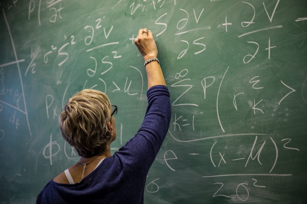 Teacher writing on chakboard